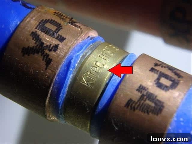 Kitec plumbing identification with orange and blue pipes and brass fittings.