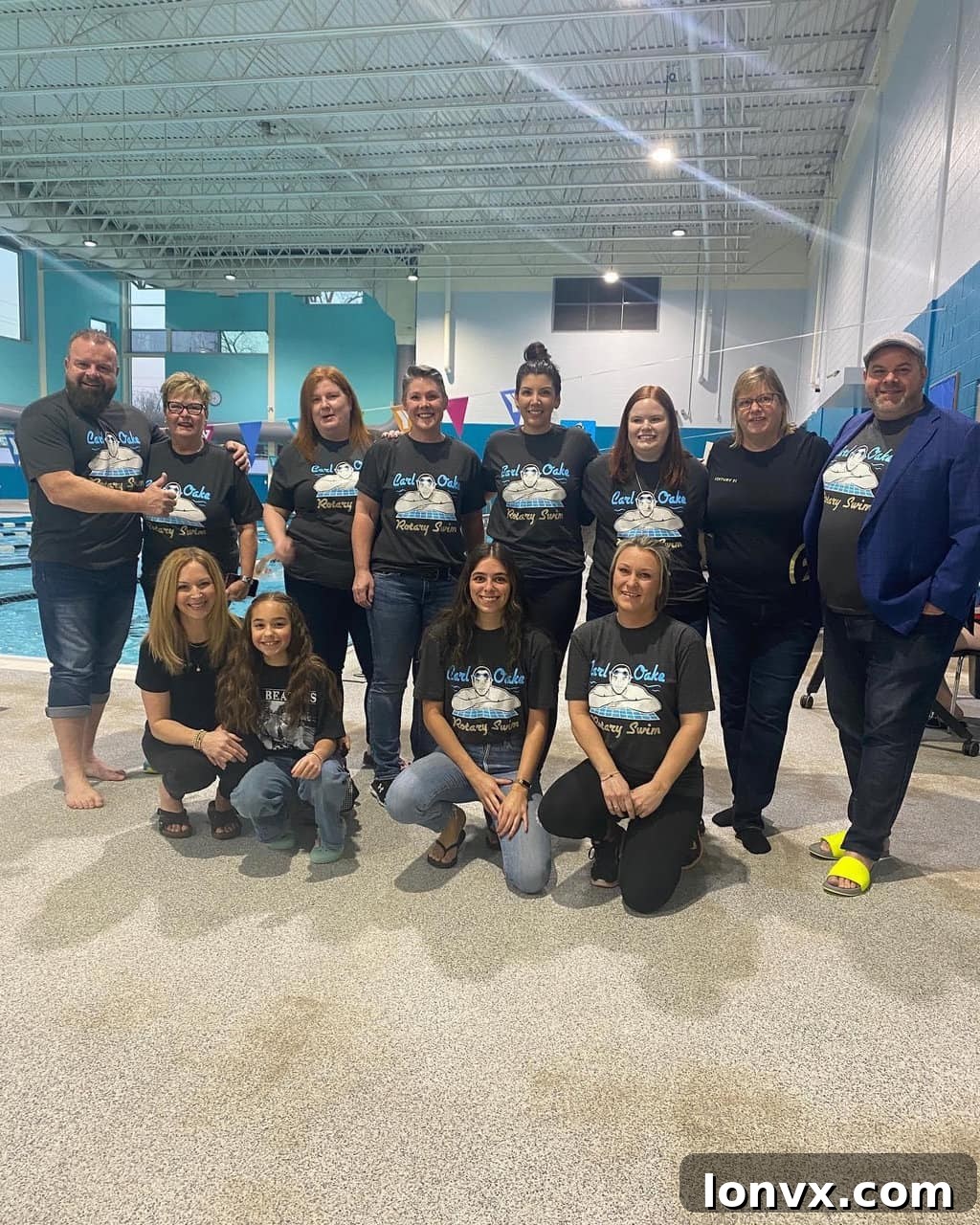 Participants of the Carl Oake Rotary Swim making a splash in the Peterborough YMCA pool, having fun and raising money for charity in vibrant costumes.