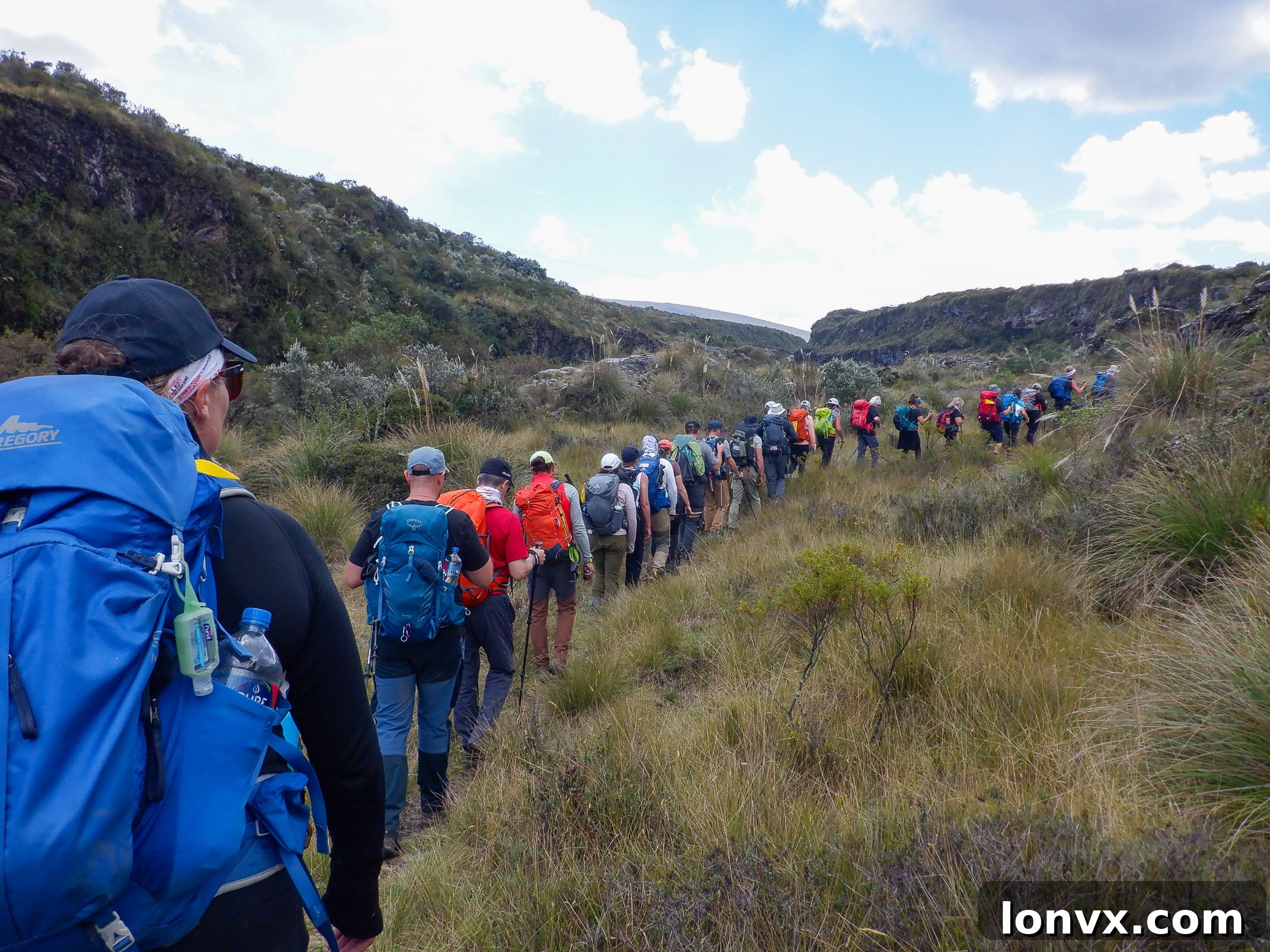 Royal LePage realtors hiking through mountainous terrain in Ecuador with clear skies