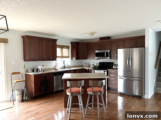 Outdated kitchen with old-fashioned light fixtures and cabinets, showing the impact of dated decor on a home's appearance.