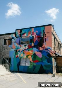 Jacquie Comrie working on a mural