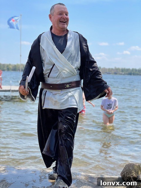 Organizer Dean Michel stands by a lake, representing the Jump in the Lake Challenge.